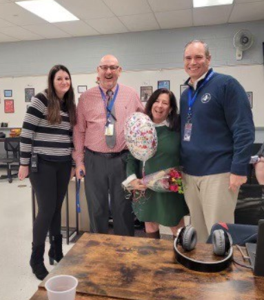 Mrs. Norton alongside Mrs. DeGeorge, Mr. Raba, and Dr. Pierro celebrating her wonderful accomplishment
