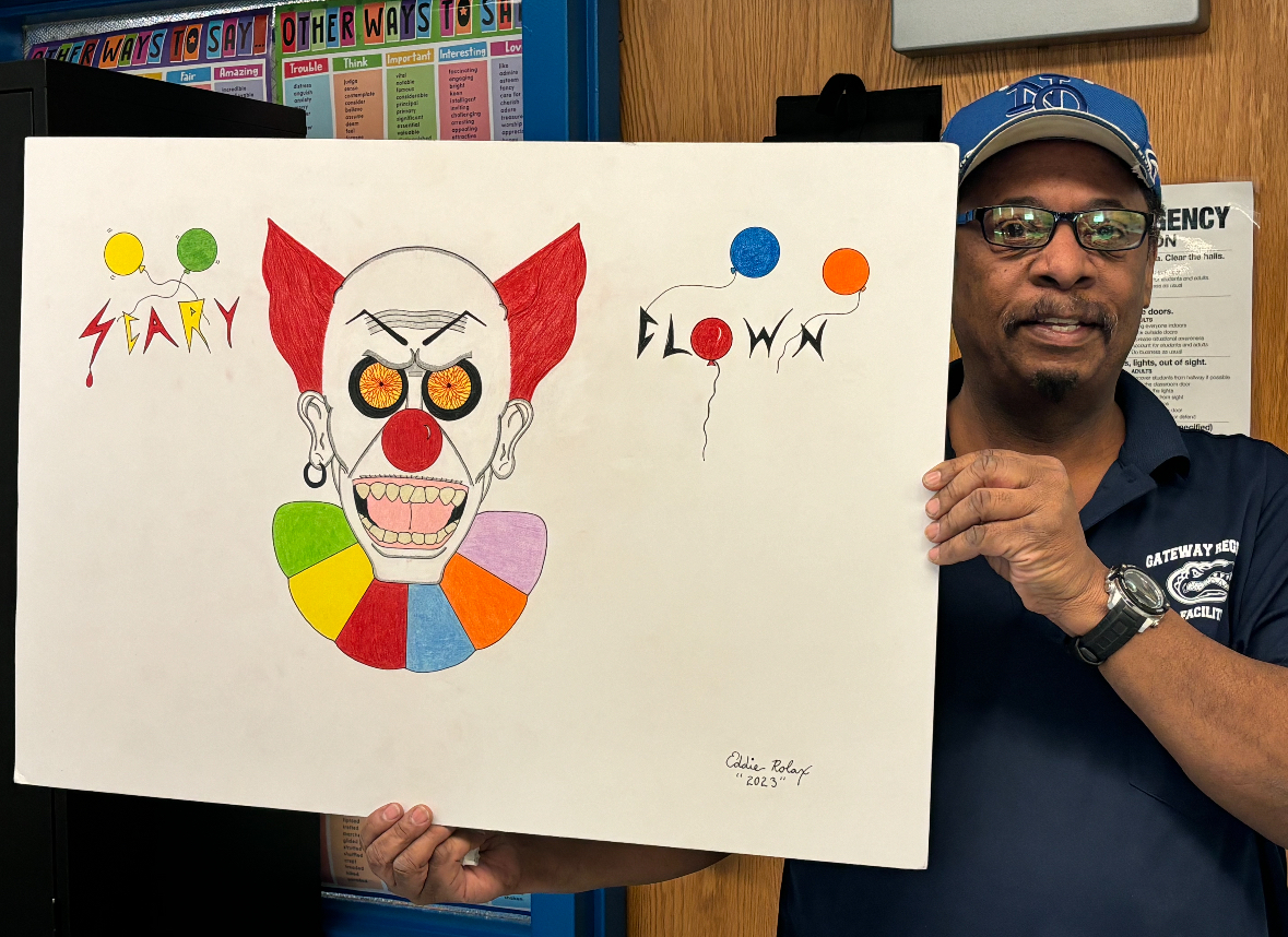 Eddie stands proudly with one of his favorite pieces, Scary Clown