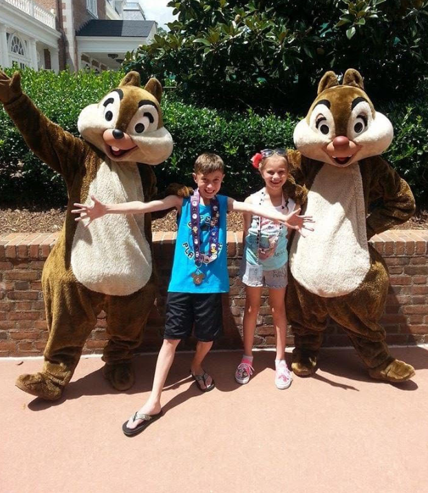 Young Kalise and Caden Miller posing with Chip and Dale on a 2014 Disney World vacation