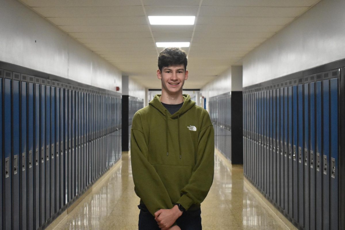 Oliver stands in the 300 wing hallway.