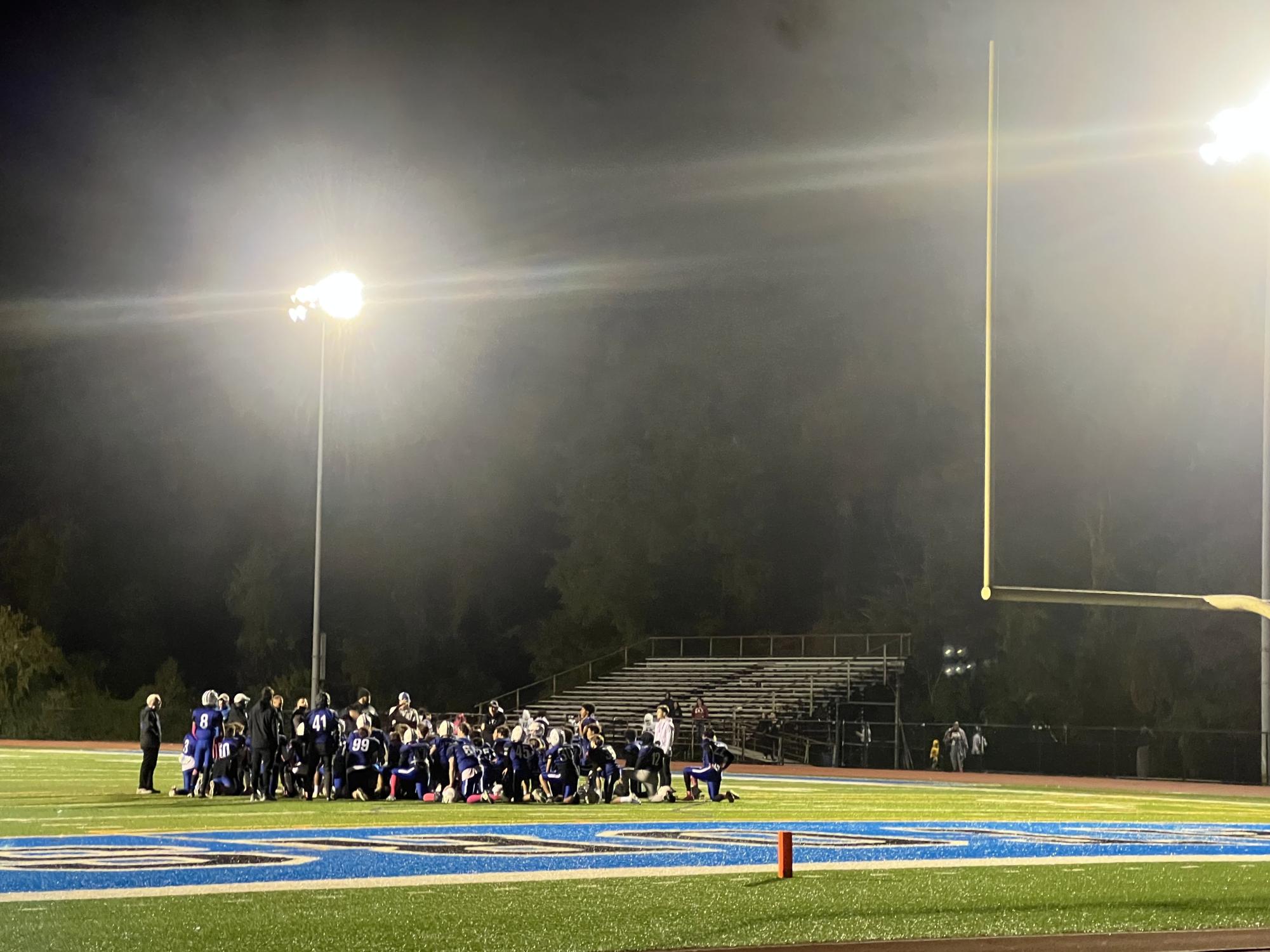 The football team gathered for a talk after the win.