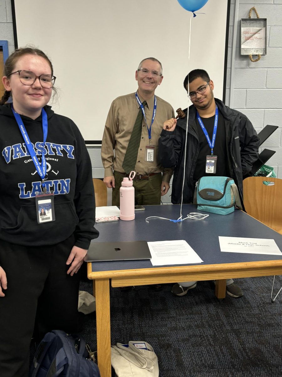 Laurel Barrett, Mr. Joyce, and Manny Gonzalez at the Mock Trial table