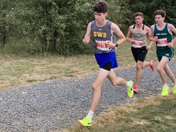 Oliver and some others running along a gravel path.