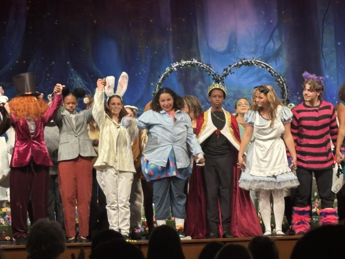 The cast of Alice In Wonderland excitedly bows as they conclude the second night of their show