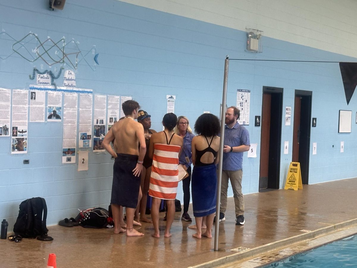 Swimmers listening to what the coaches have to say