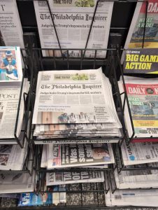 A rack of newspapers at a store 