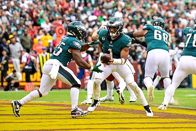 Jalen Hurts gives a hand-off to Boston Scott against the Washington Commanders
