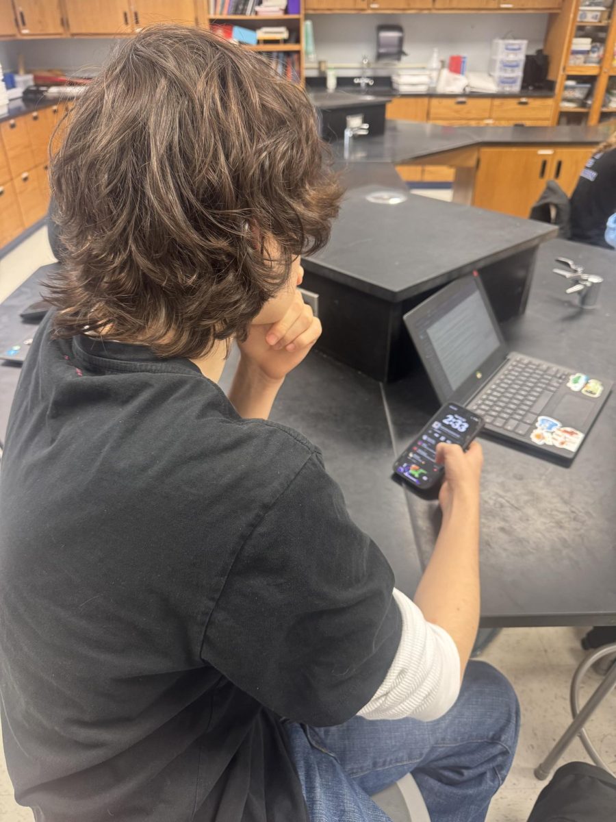A student (Lincoln Campagna) on his cellphone during a class—something which he will be unable to do next year