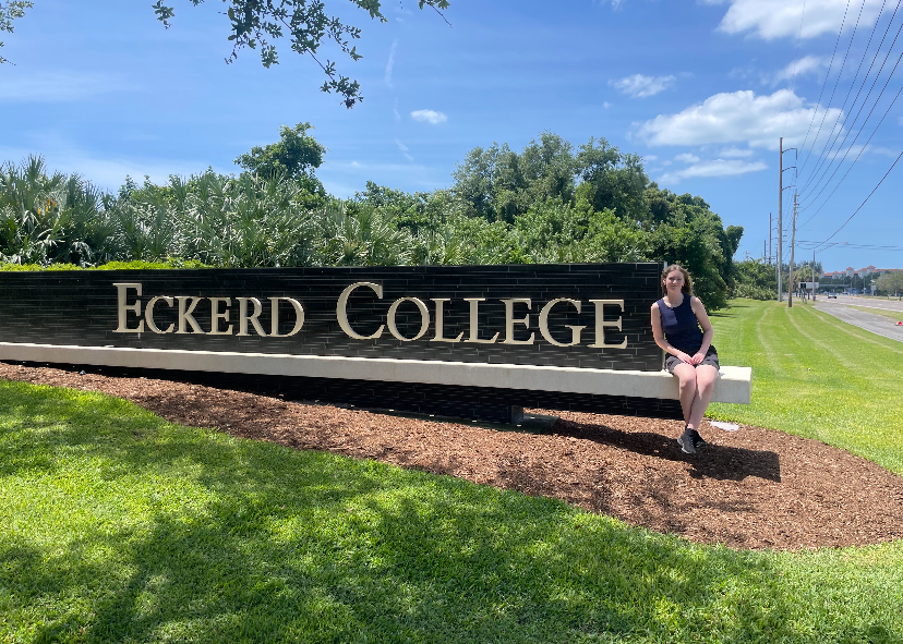 Abria Joshua posing with the Eckerd College sign during her visit there