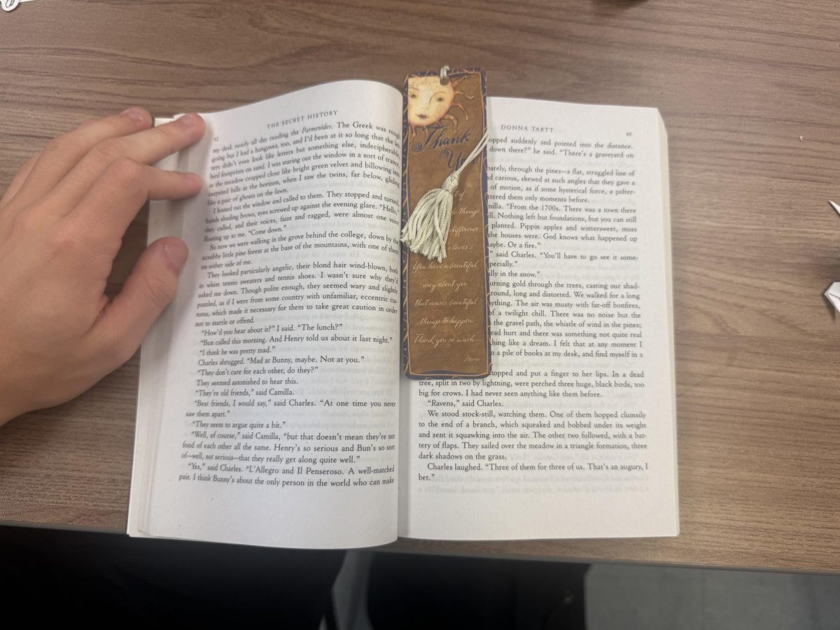 An image of a book (The Secret History by Donna Tartt) halfway open